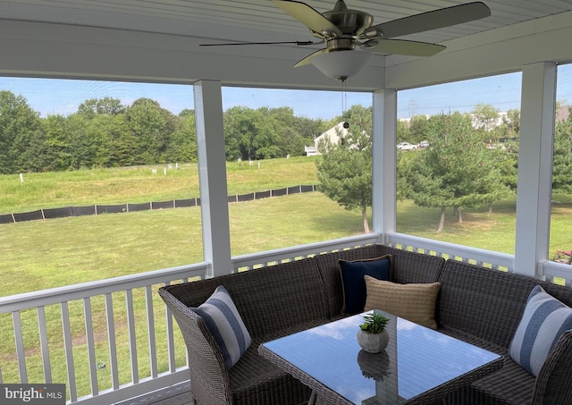 sunroom / solarium featuring ceiling fan