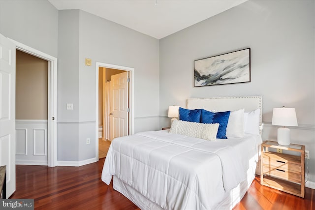 bedroom with dark hardwood / wood-style flooring