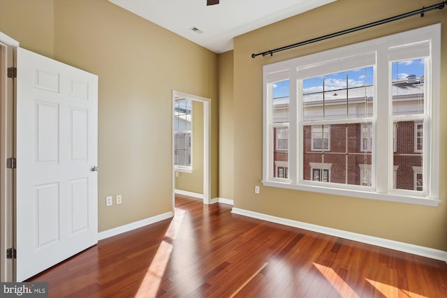 unfurnished room with wood-type flooring