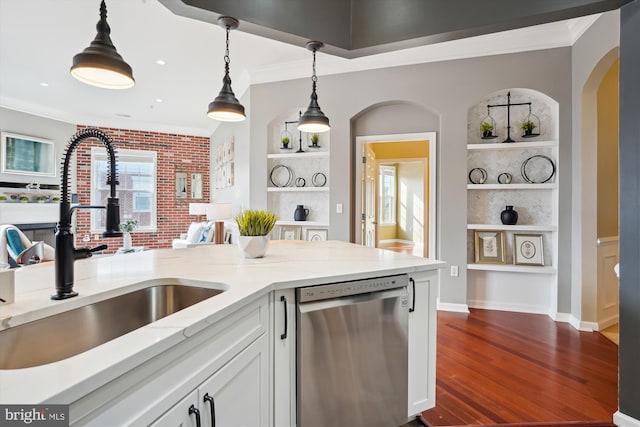 kitchen with sink, dishwasher, white cabinetry, hanging light fixtures, and built in shelves