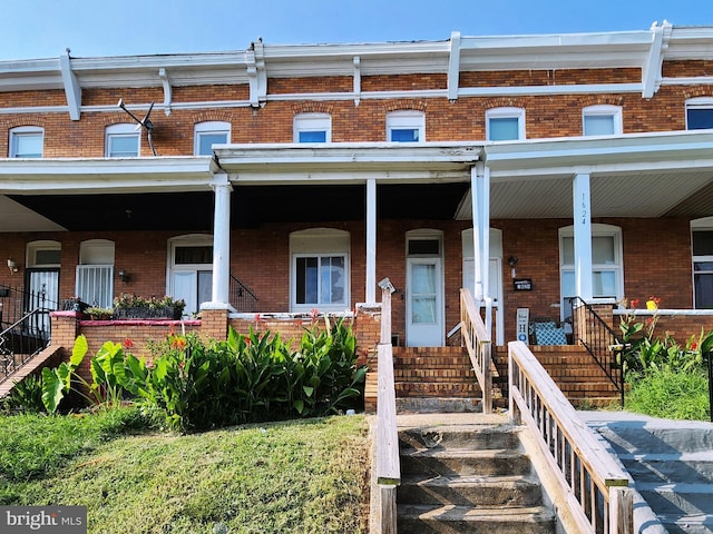 townhome / multi-family property featuring a porch