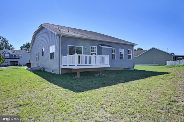 rear view of property with a deck and a lawn