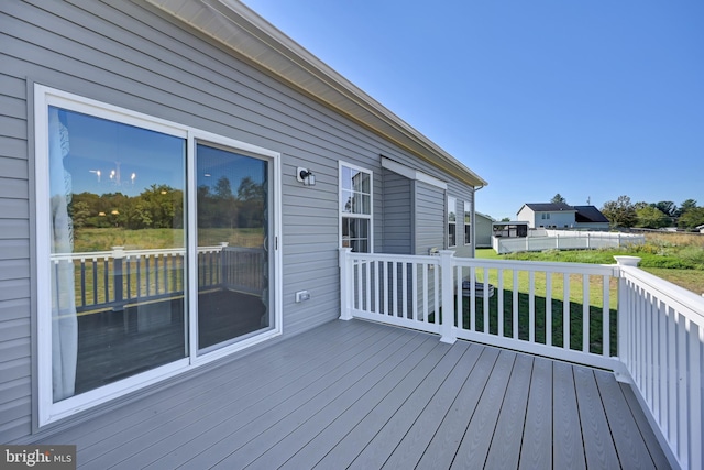 wooden deck with a lawn