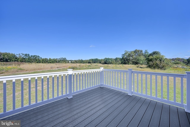 wooden terrace featuring a yard