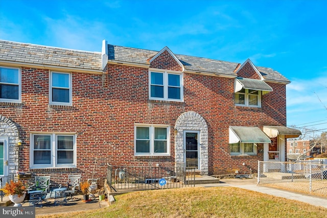 view of front of house with a patio area and a front yard