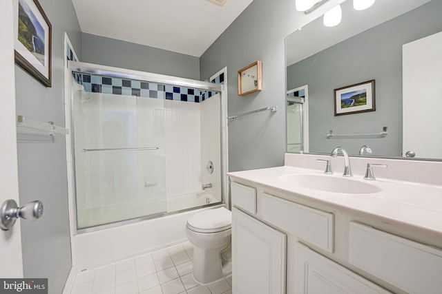 full bathroom featuring toilet, bath / shower combo with glass door, tile patterned floors, and vanity