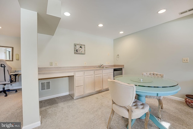 carpeted dining space featuring sink and built in desk