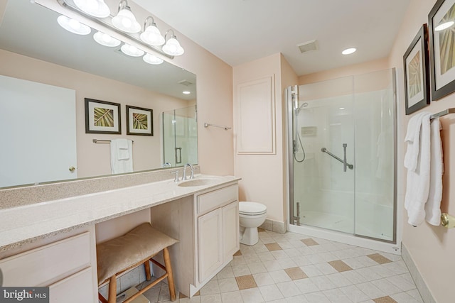 bathroom featuring a shower with shower door, toilet, and vanity