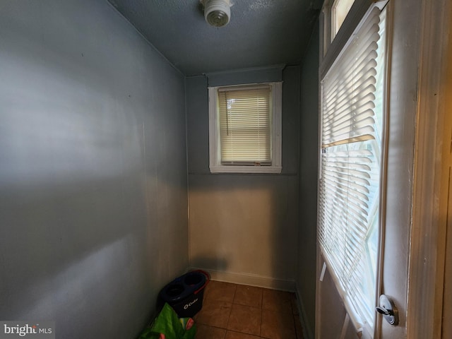 interior space with dark tile patterned flooring