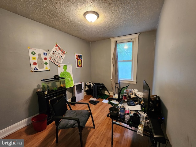 office with a textured ceiling and wood-type flooring