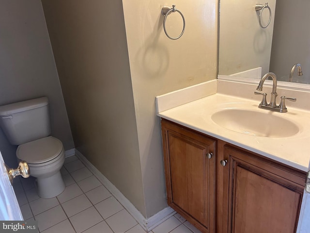 bathroom featuring vanity, tile patterned flooring, and toilet