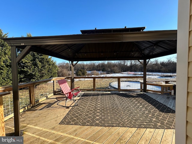 wooden terrace featuring a gazebo