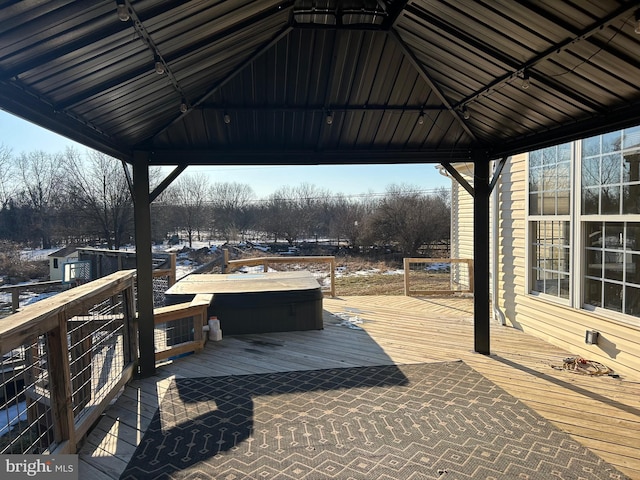 wooden deck featuring a gazebo and a covered hot tub