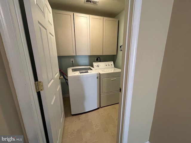 washroom with cabinets and independent washer and dryer