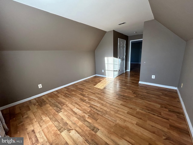 bonus room featuring vaulted ceiling and hardwood / wood-style floors