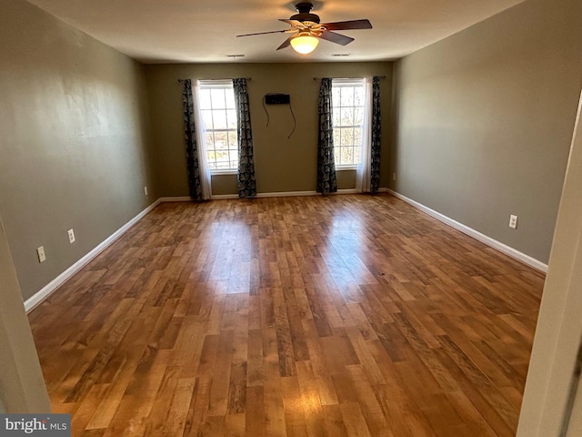 unfurnished room featuring hardwood / wood-style floors and ceiling fan