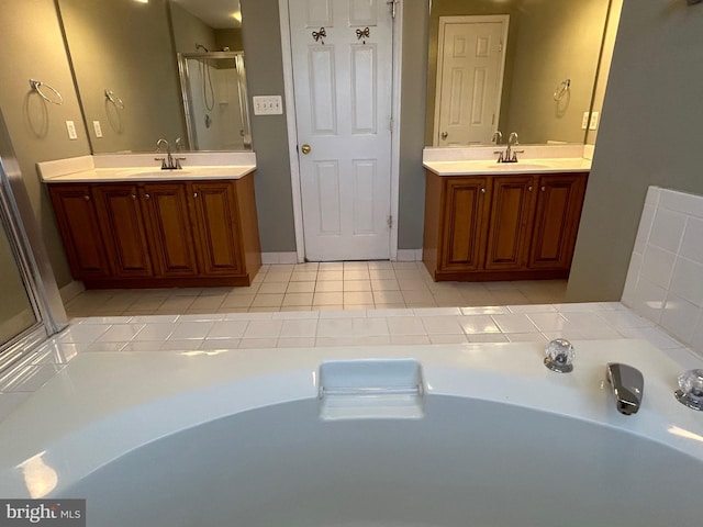 bathroom featuring vanity, an enclosed shower, and tile patterned floors