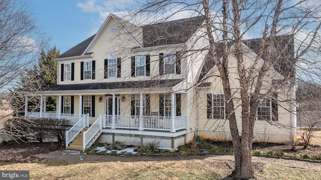 colonial-style house featuring covered porch