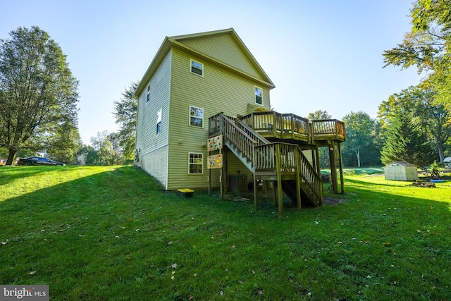 rear view of house with a storage shed, a wooden deck, and a lawn