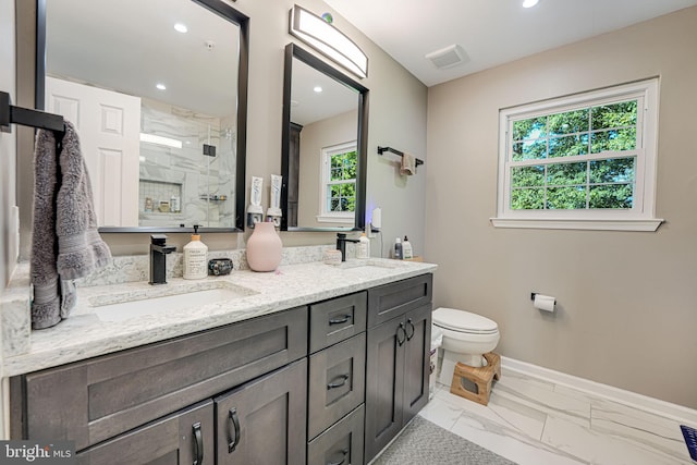 bathroom with vanity, toilet, and a shower with shower door