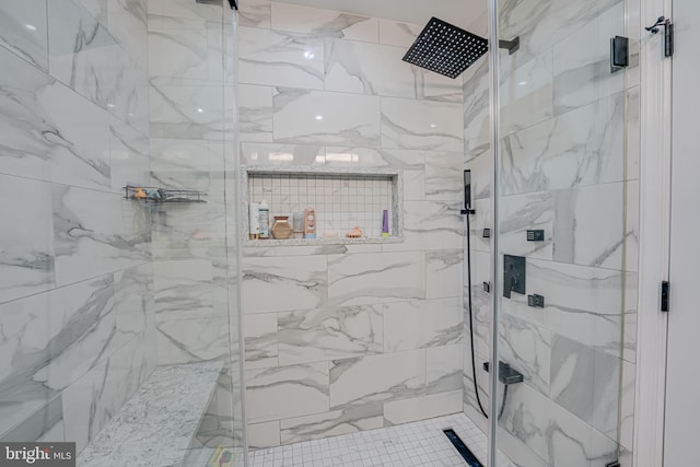 bathroom with a shower with door