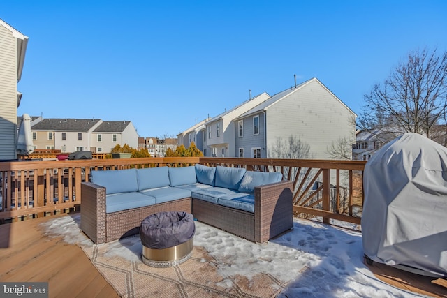 snow covered deck featuring area for grilling and an outdoor hangout area