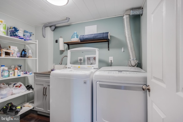 washroom with washing machine and dryer and cabinets