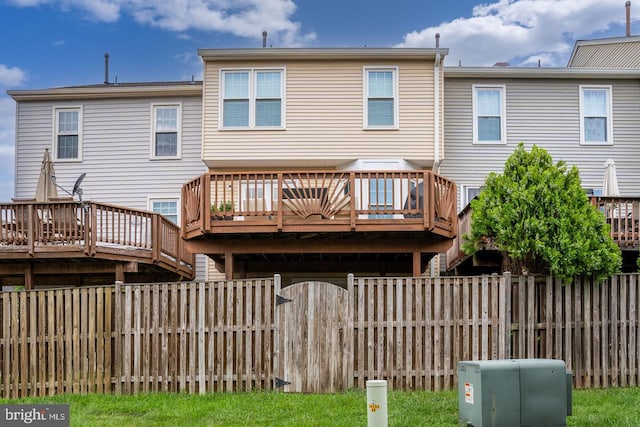 back of house featuring a wooden deck