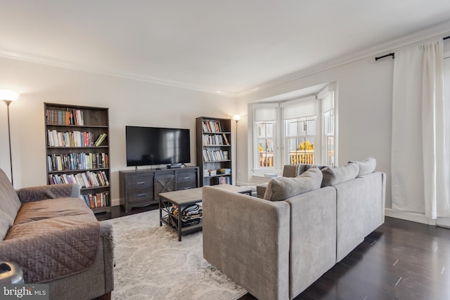 living room featuring ornamental molding and dark hardwood / wood-style floors