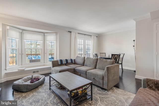 living room with crown molding, dark hardwood / wood-style floors, and french doors