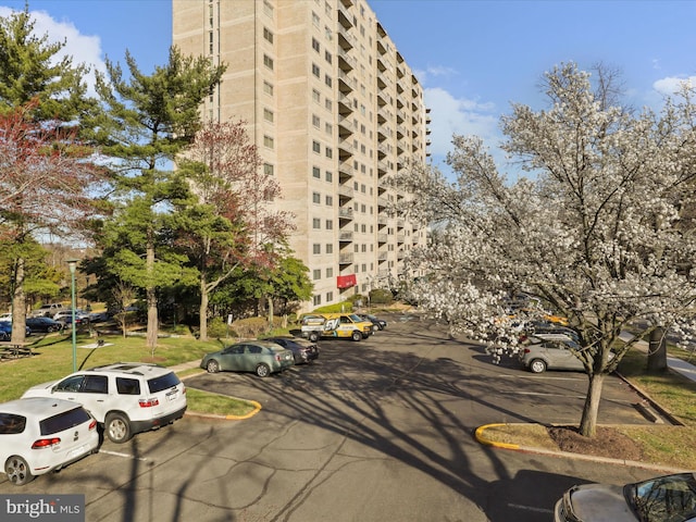 view of building exterior featuring uncovered parking