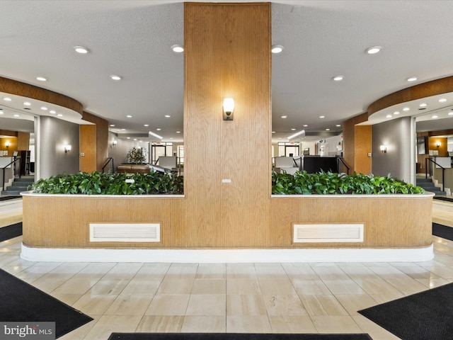 reception area with stairway and visible vents