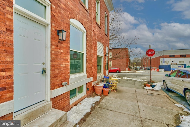 exterior space featuring brick siding