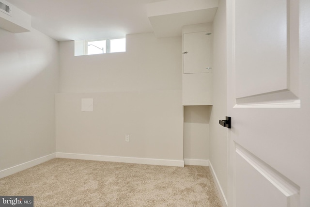 laundry room with light carpet, visible vents, and baseboards