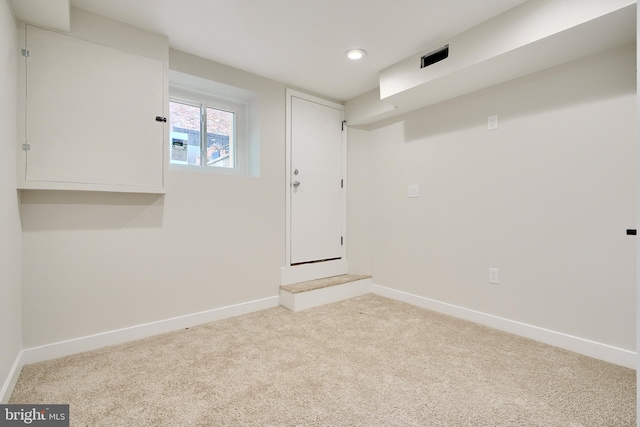 basement featuring recessed lighting, baseboards, and light colored carpet