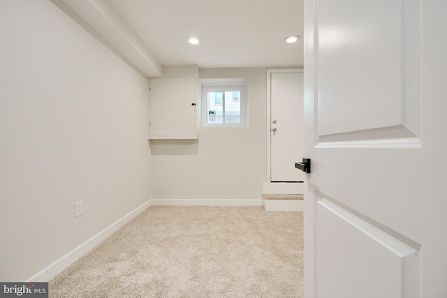 spare room with baseboards, recessed lighting, and light colored carpet