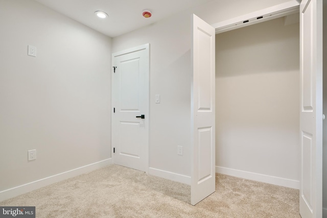 unfurnished bedroom with baseboards, recessed lighting, and light colored carpet