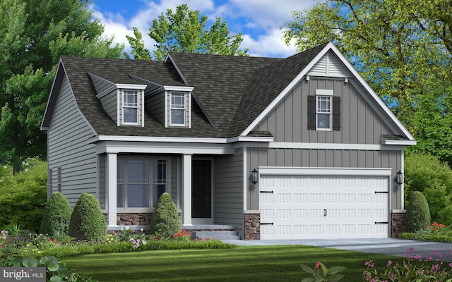 view of front of house with a front yard and a garage