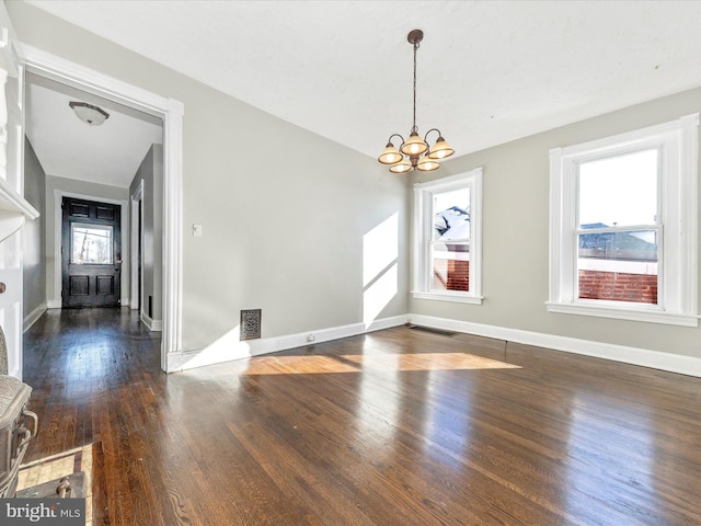 interior space featuring a notable chandelier and dark hardwood / wood-style flooring