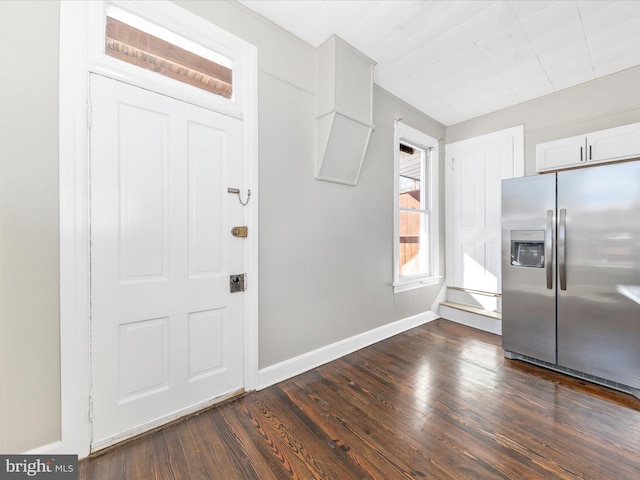 kitchen with dark hardwood / wood-style flooring, white cabinets, and stainless steel refrigerator with ice dispenser