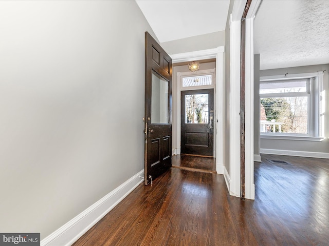 entrance foyer featuring dark hardwood / wood-style floors and a textured ceiling