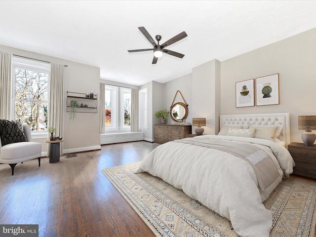 bedroom with dark hardwood / wood-style floors and ceiling fan