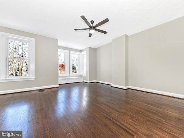 unfurnished room with dark wood-type flooring and ceiling fan