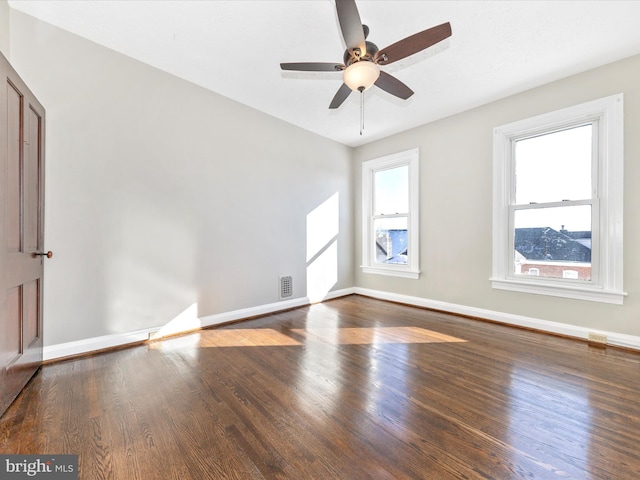 empty room featuring ceiling fan and dark hardwood / wood-style flooring