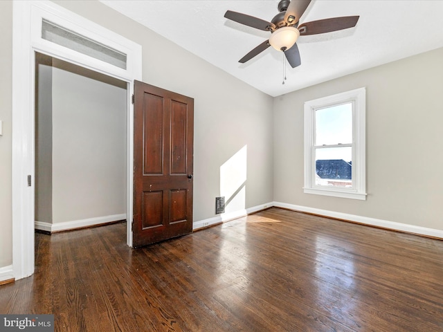 unfurnished bedroom with dark wood-type flooring, a closet, and ceiling fan