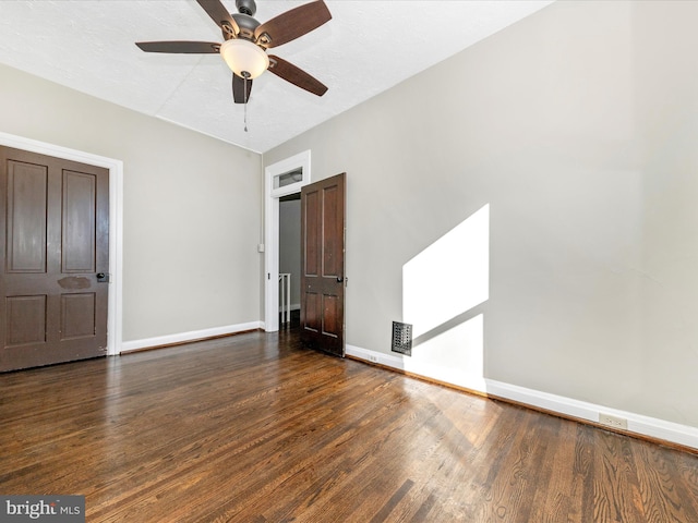 unfurnished bedroom featuring dark wood-type flooring and ceiling fan