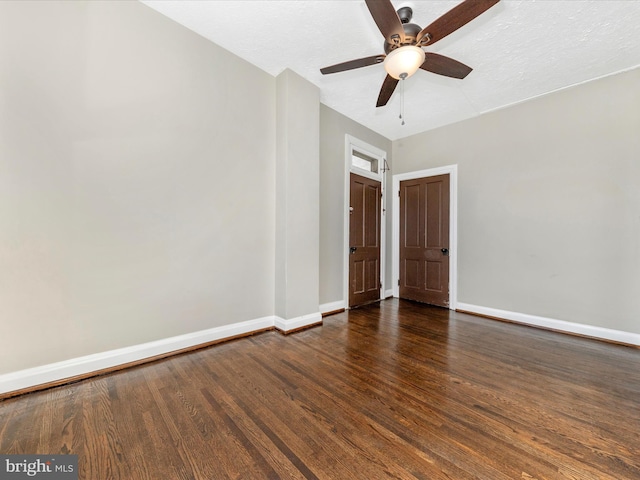 empty room with dark hardwood / wood-style floors and ceiling fan