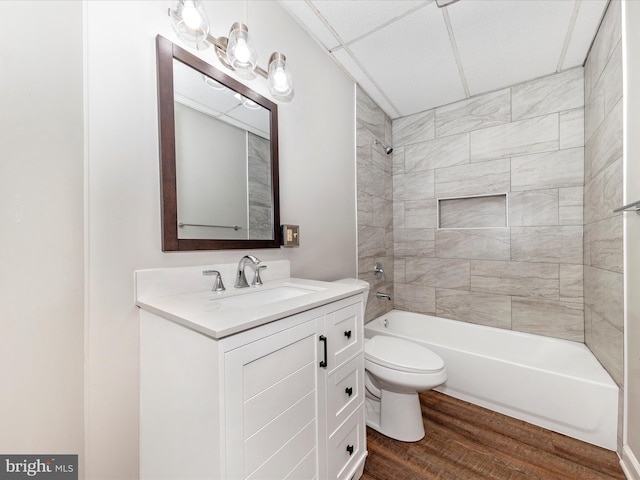 full bathroom featuring vanity, wood-type flooring, toilet, and tiled shower / bath