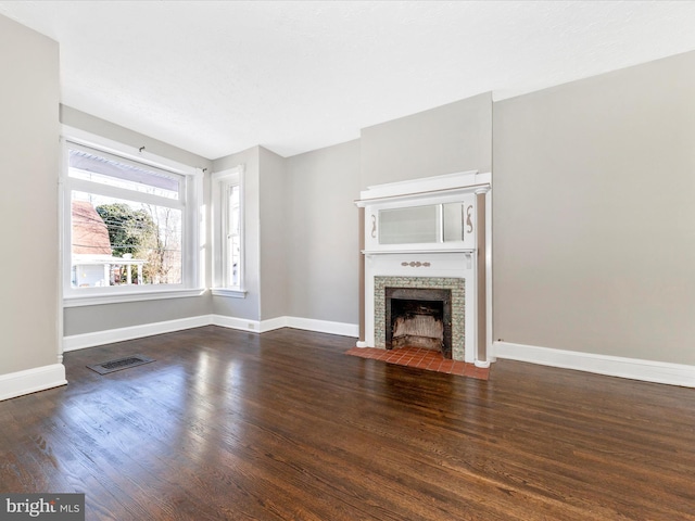 unfurnished living room with dark hardwood / wood-style flooring