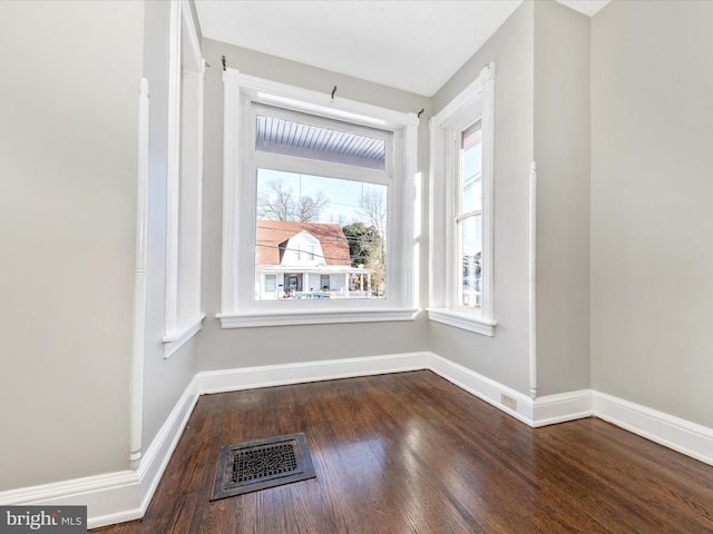 unfurnished room with dark hardwood / wood-style floors